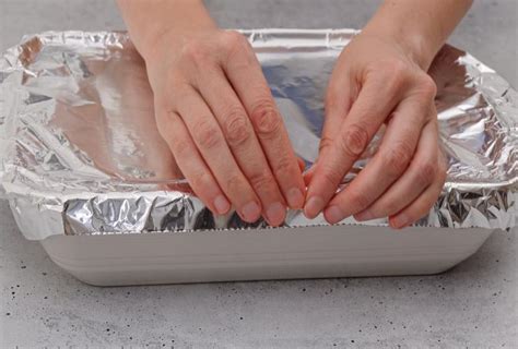 Bacinella con argenteria e carta stagnola per lucidatura