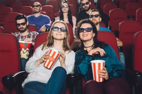 Persone con mascherine che guardano un film al cinema