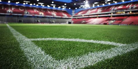 Logo DAZN con sfondo di un campo da calcio