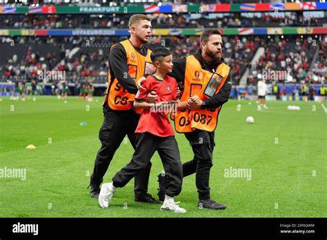 Steward che rimuovono un tifoso dal campo
